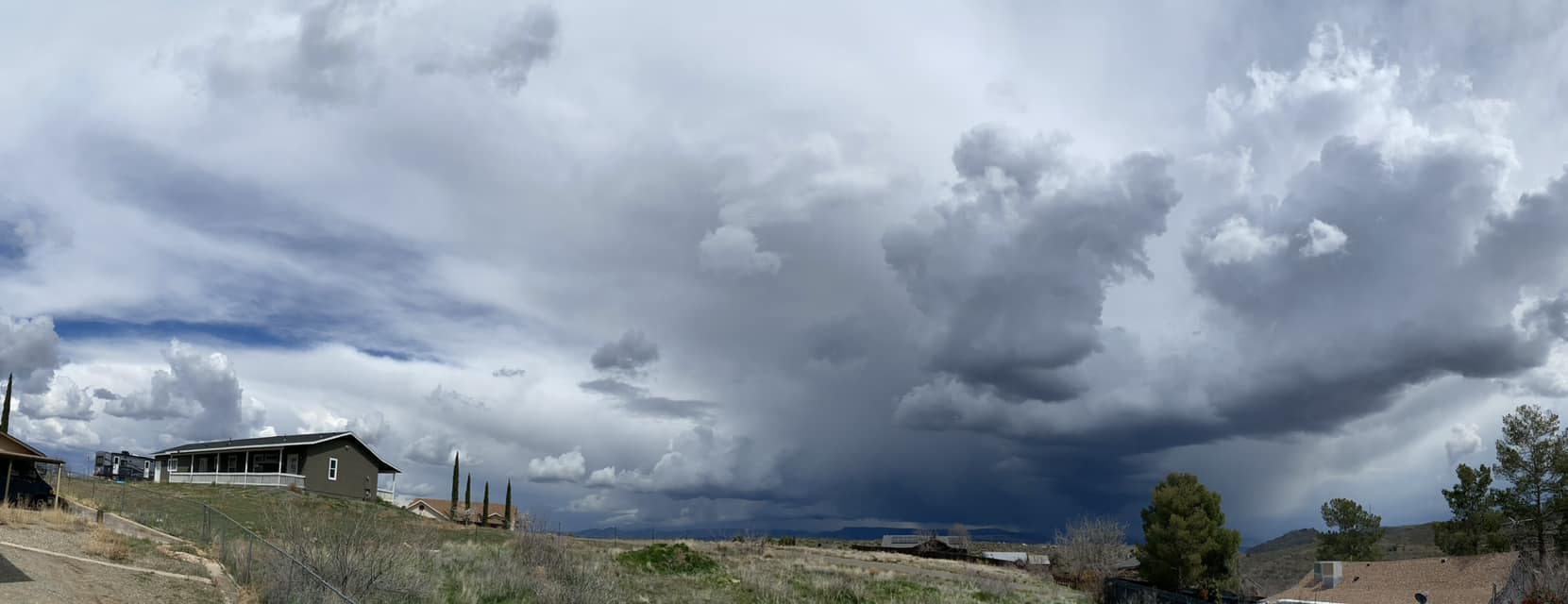 Dramatic panoramic photograph of the cloud filled sky from the doorstep of author's home in Arizona.